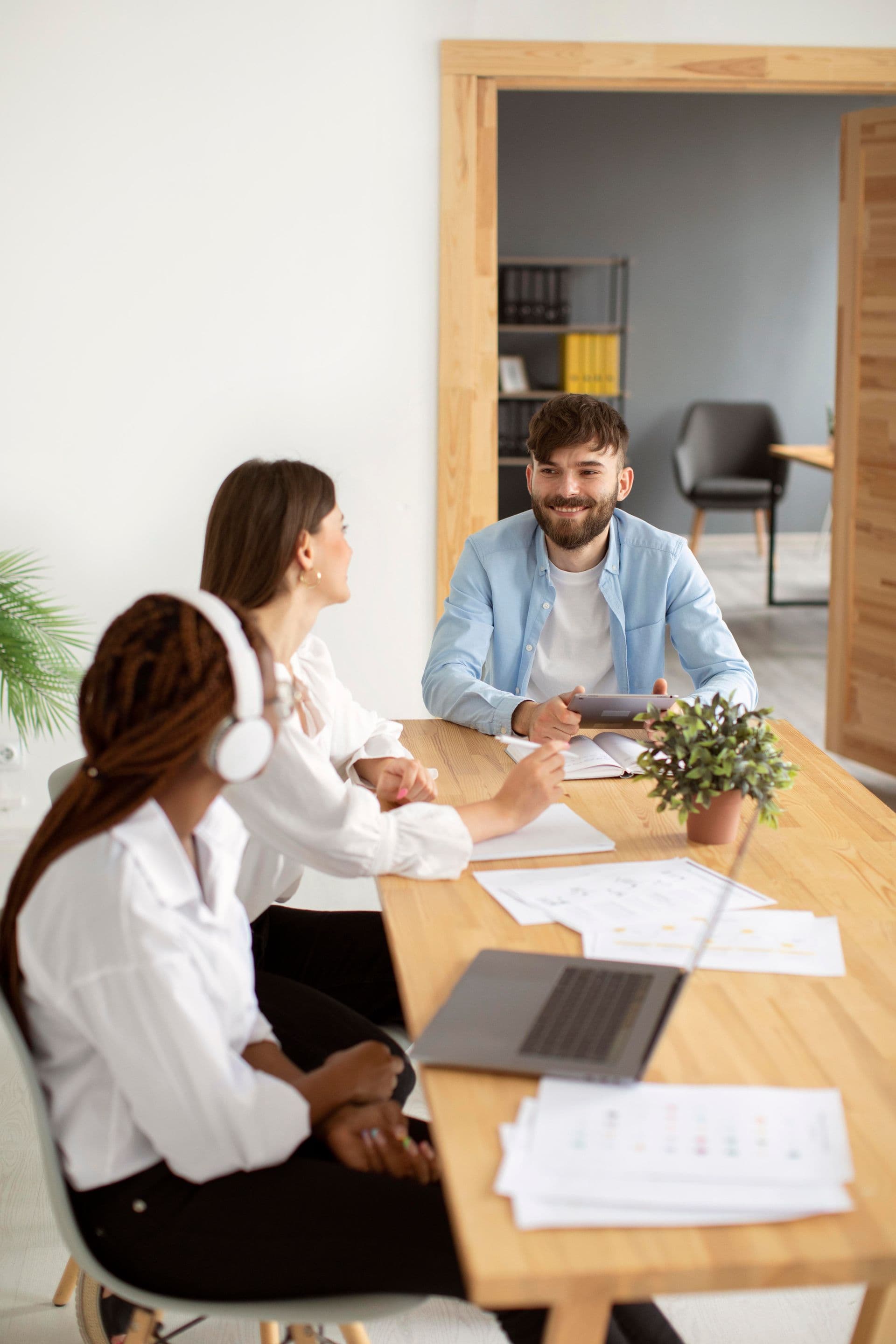 Three colleagues reviewing finance documents together at a table